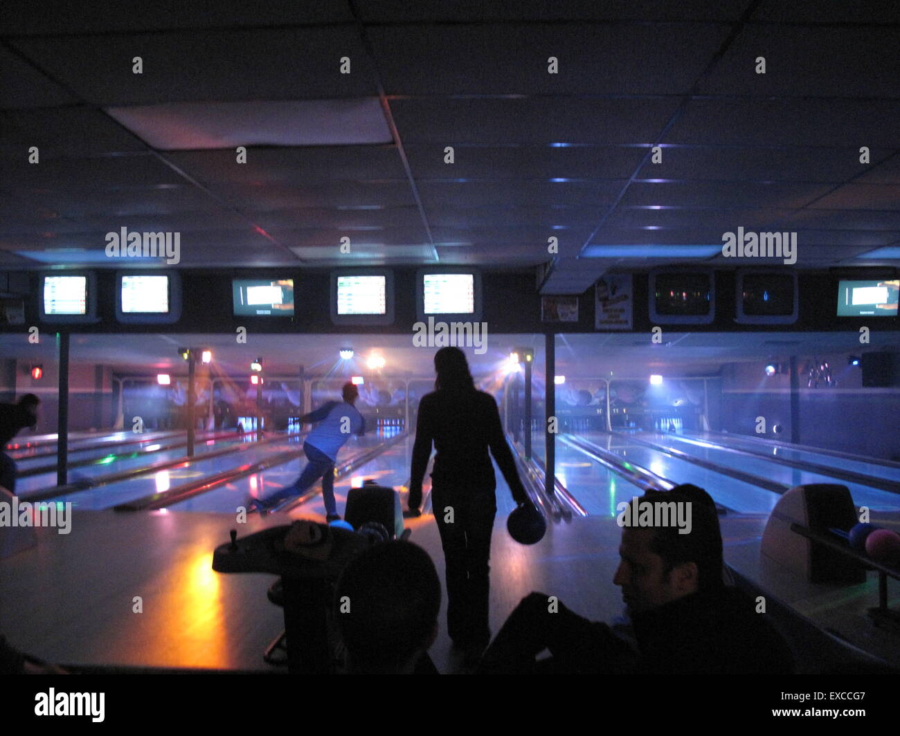 Les quilleurs de nuit glow bowling à un bowling Banque D'Images