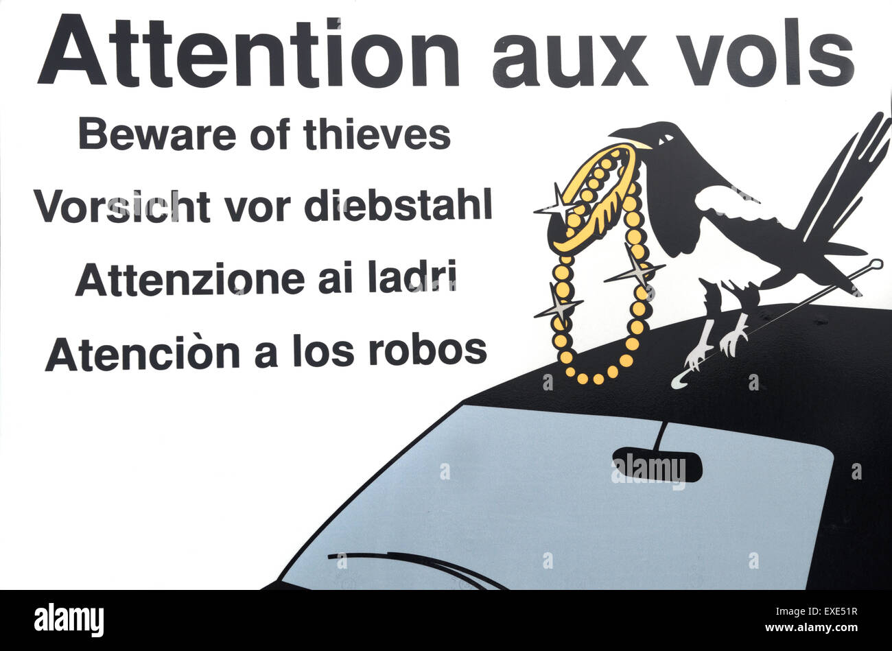 La Pie voleuse avec bijoux sur toit de voiture. Partie d'un signe Attention les automobilistes sur le vol de voiture dans une station-service à moteur France Banque D'Images