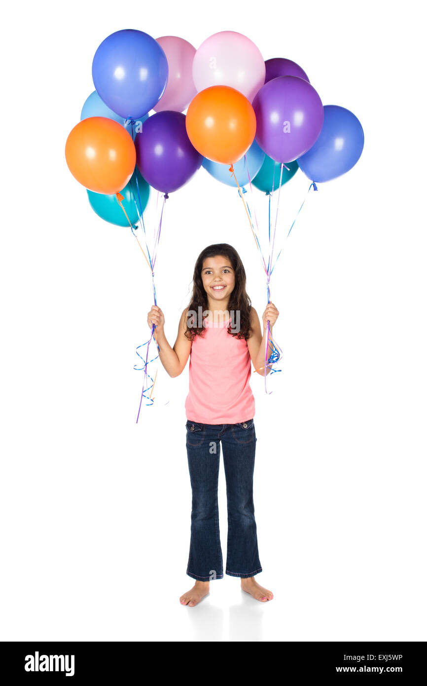 Pretty cute young girl wearing a haut rose et un jean bleu. La jeune fille tient un bouquet de ballons à l'hélium de couleur vive. Banque D'Images