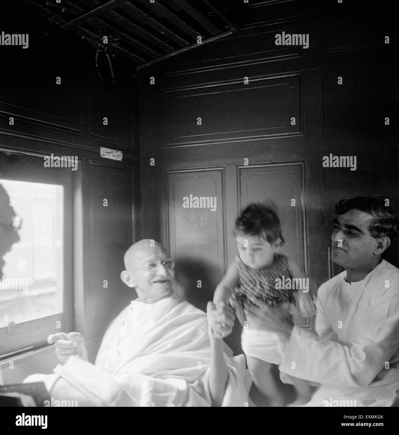 Mahatma Gandhi à jouer avec l'enfant de Girdharilal Kripalani dans le compartiment de train station à Nagpur, 1941 ; PAS DE MR Banque D'Images