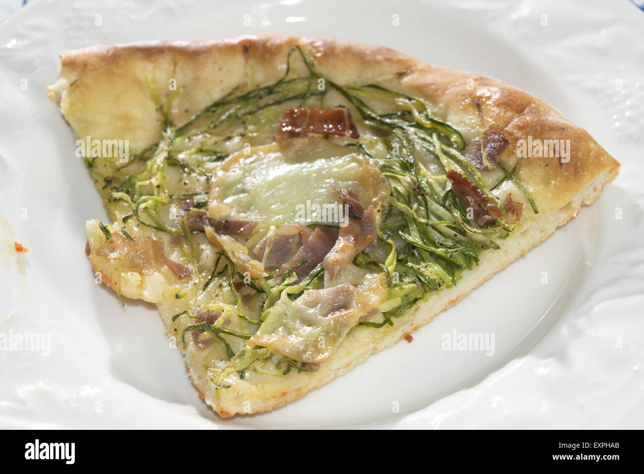 Coin de courgettes fromage fait maison et pizza sur une assiette blanche Banque D'Images