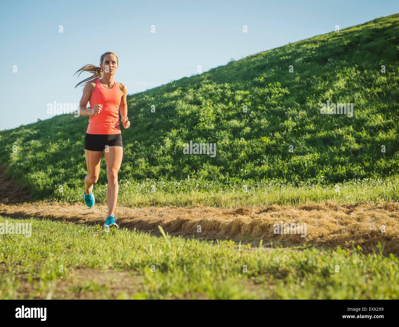 Woman running in field Banque D'Images