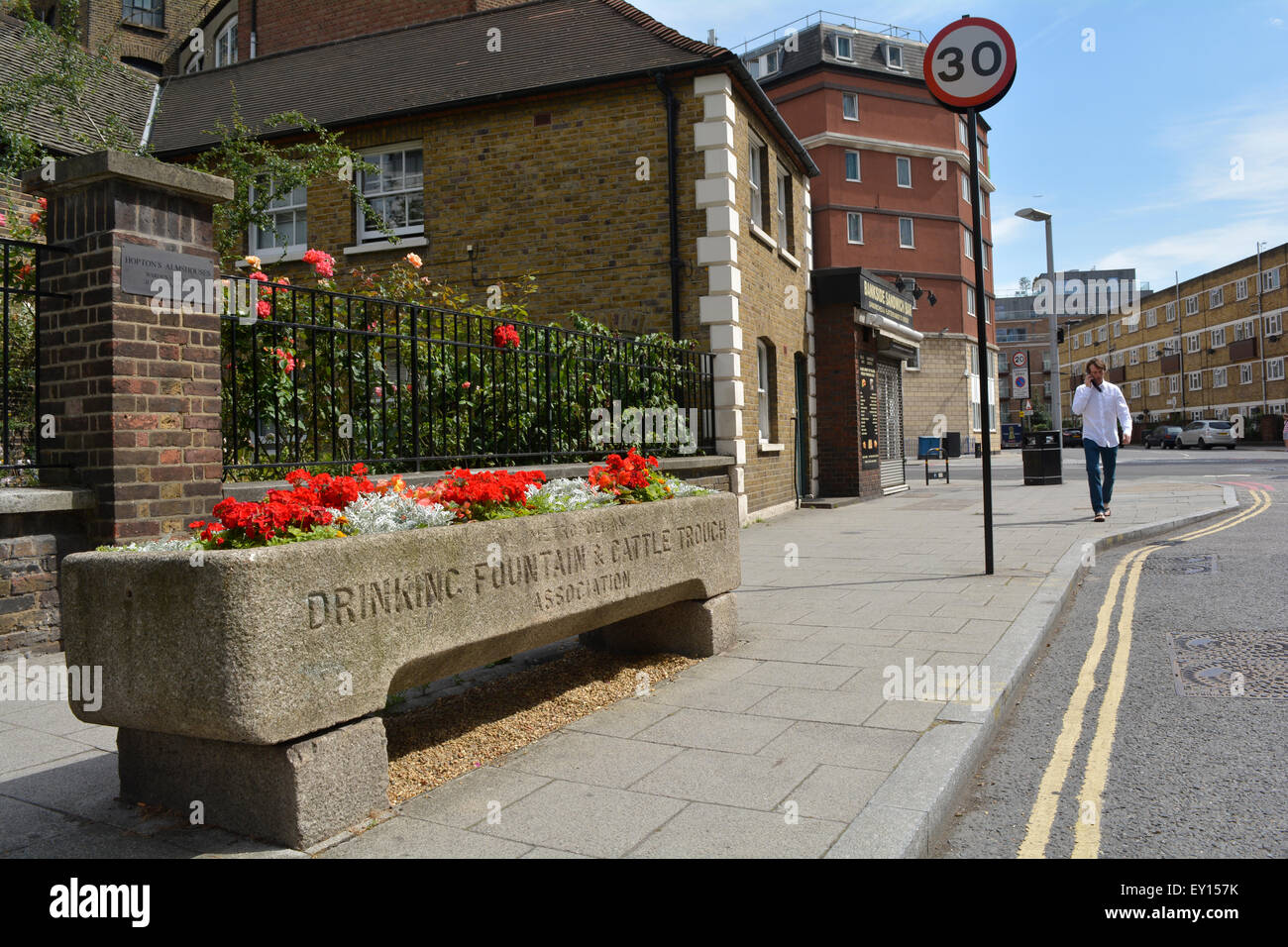Géraniums rouges poussant dans une fontaine de Londres et une cuvette de bétail Banque D'Images