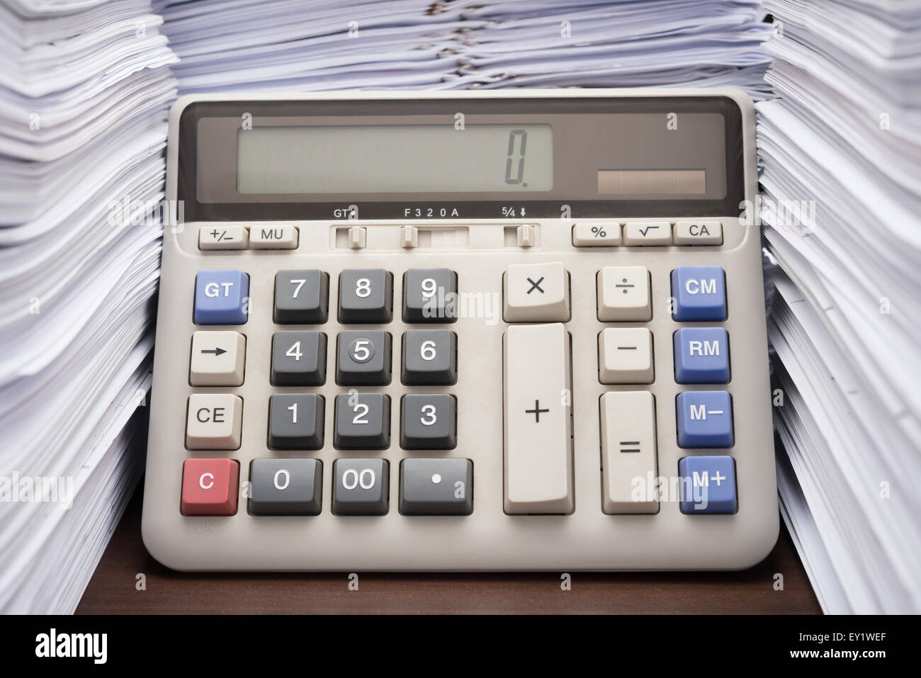 Pile de documents sur le bureau de la haute pile avec la calculatrice sur office 24 Banque D'Images