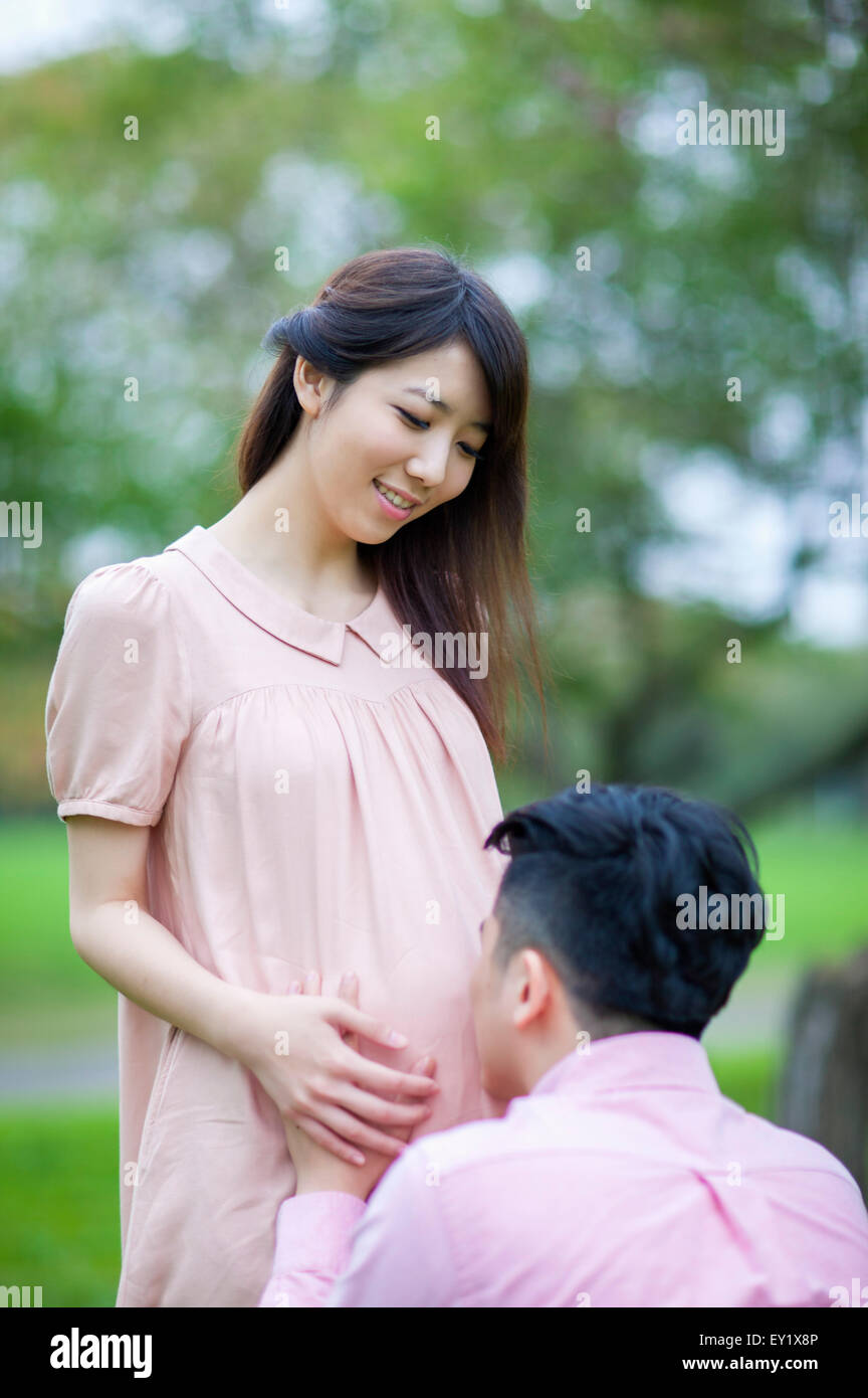 Jeune homme embrassant l'abdomen de la femme enceinte, Banque D'Images