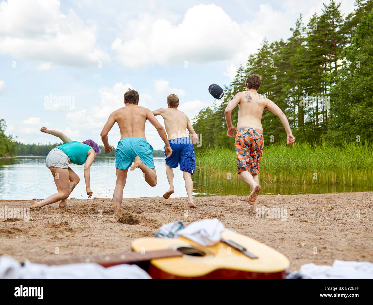 Le groupe des gens s'exécute dans le lac, journée d'été Banque D'Images