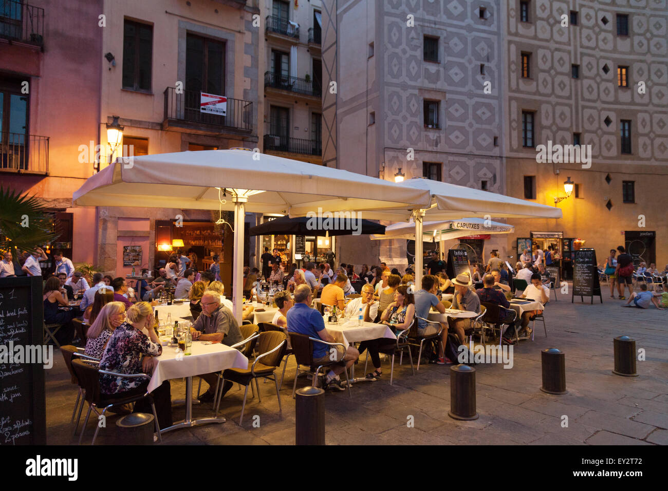 Les personnes mangeant le soir dans un restaurant en plein air dans le quartier de la Ribera, Barcelone, Espagne Europe Banque D'Images