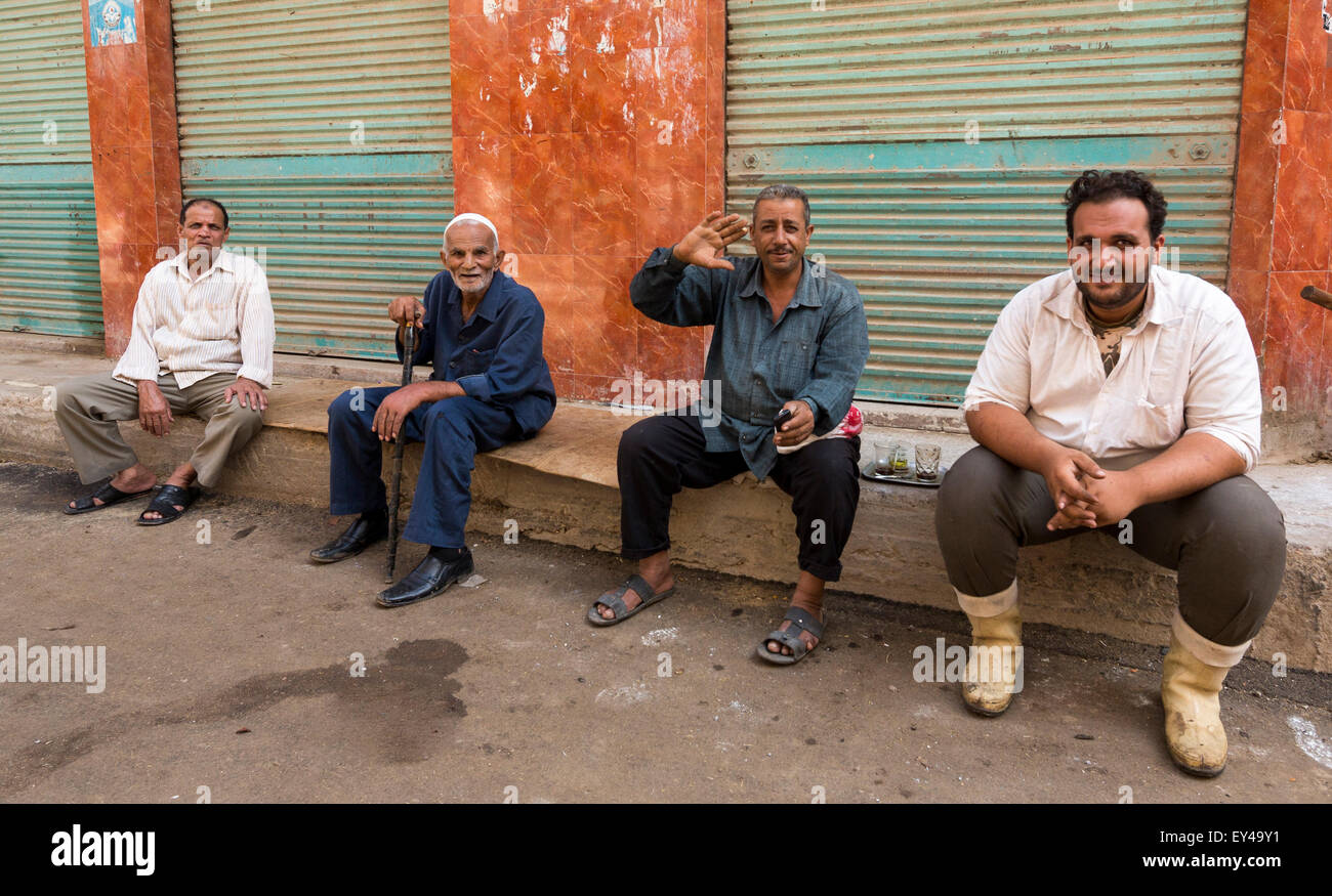 Homme assis sur rue près du souk, Rosetta, l'Égypte Banque D'Images