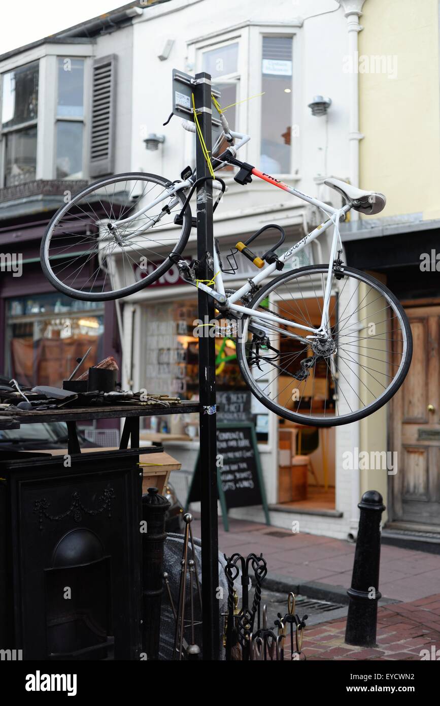 Vélo verrouillé à un poste dans une rue à Brighton Banque D'Images