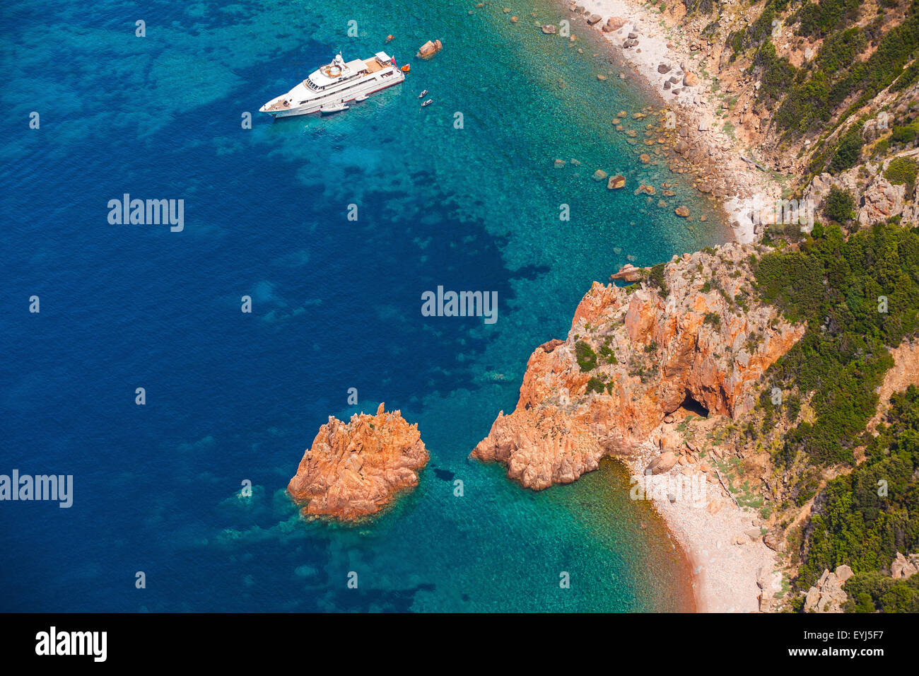 Luxury yacht de plaisance blanc ancré près plage rocheuse de l'île de Corse, birds eye view Banque D'Images