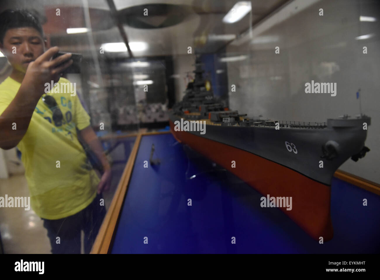 New York, USA. 30 juillet, 2015. Les touristes voir un modèle de USS Missouri (BB-63) à Honolulu, Hawaï, États-Unis, le 30 juillet 2015. USS Missouri (BB-63) était l'emplacement où le Japon a signé la remise des documents à la fin de la Seconde Guerre mondiale. En 1998, ce navire a été donné à l'USS Arizona Memorial Association et est devenu un bateau musée à Pearl Harbor, Hawaii. © Yin Bogu/Xinhua/Alamy Live News Banque D'Images