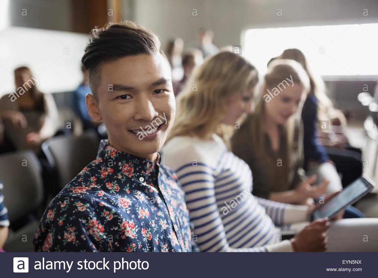 Portrait of smiling student in lecture audience Banque D'Images