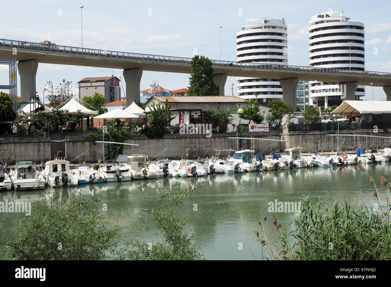 Route surélevée le long du fleuve Pescara bordée par des bateaux de plaisance. Banque D'Images