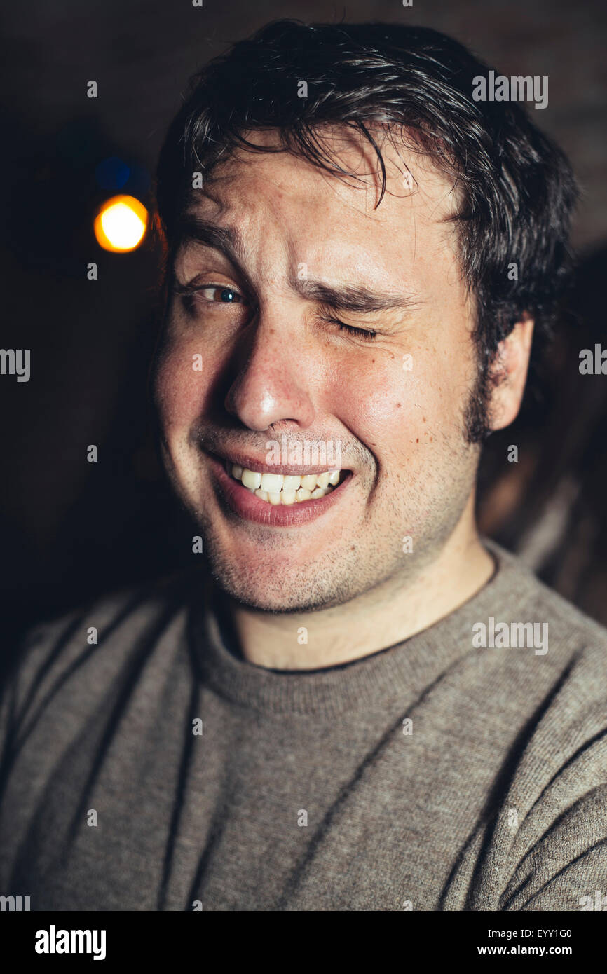 Close up of Hispanic man winking Banque D'Images