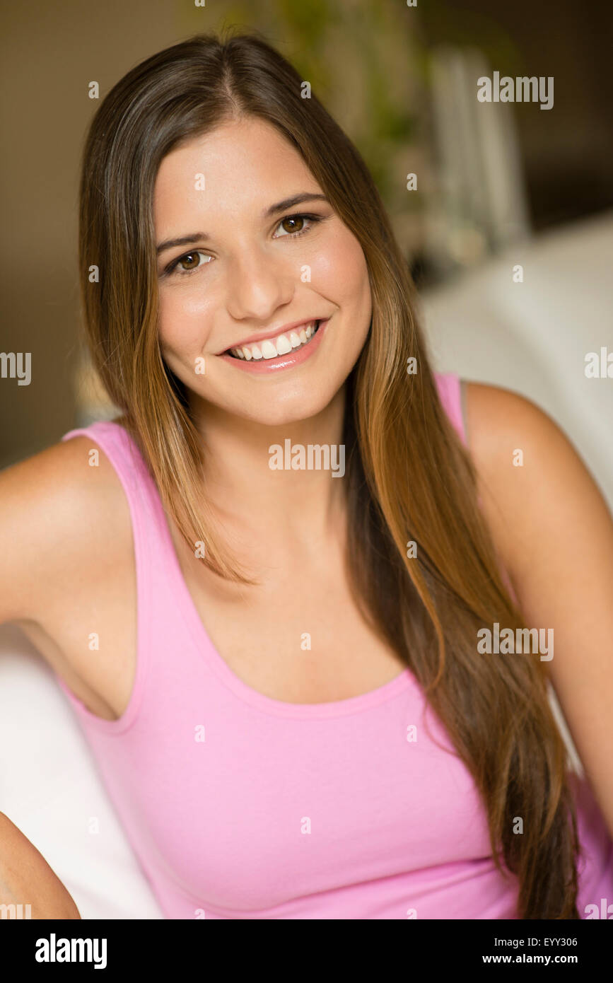 Caucasian woman with long hair sitting on sofa Banque D'Images