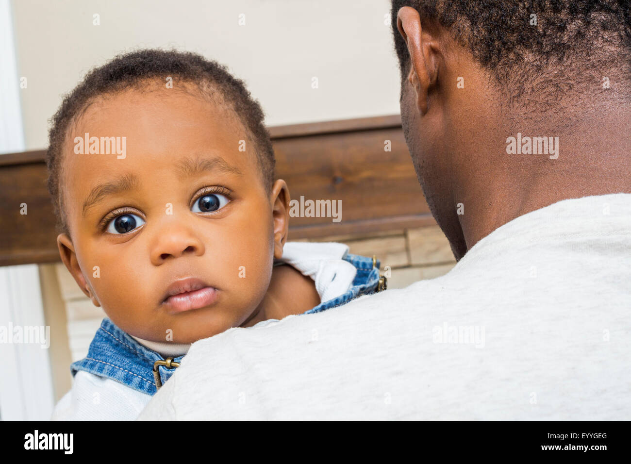 Close up of Black father holding baby son Banque D'Images