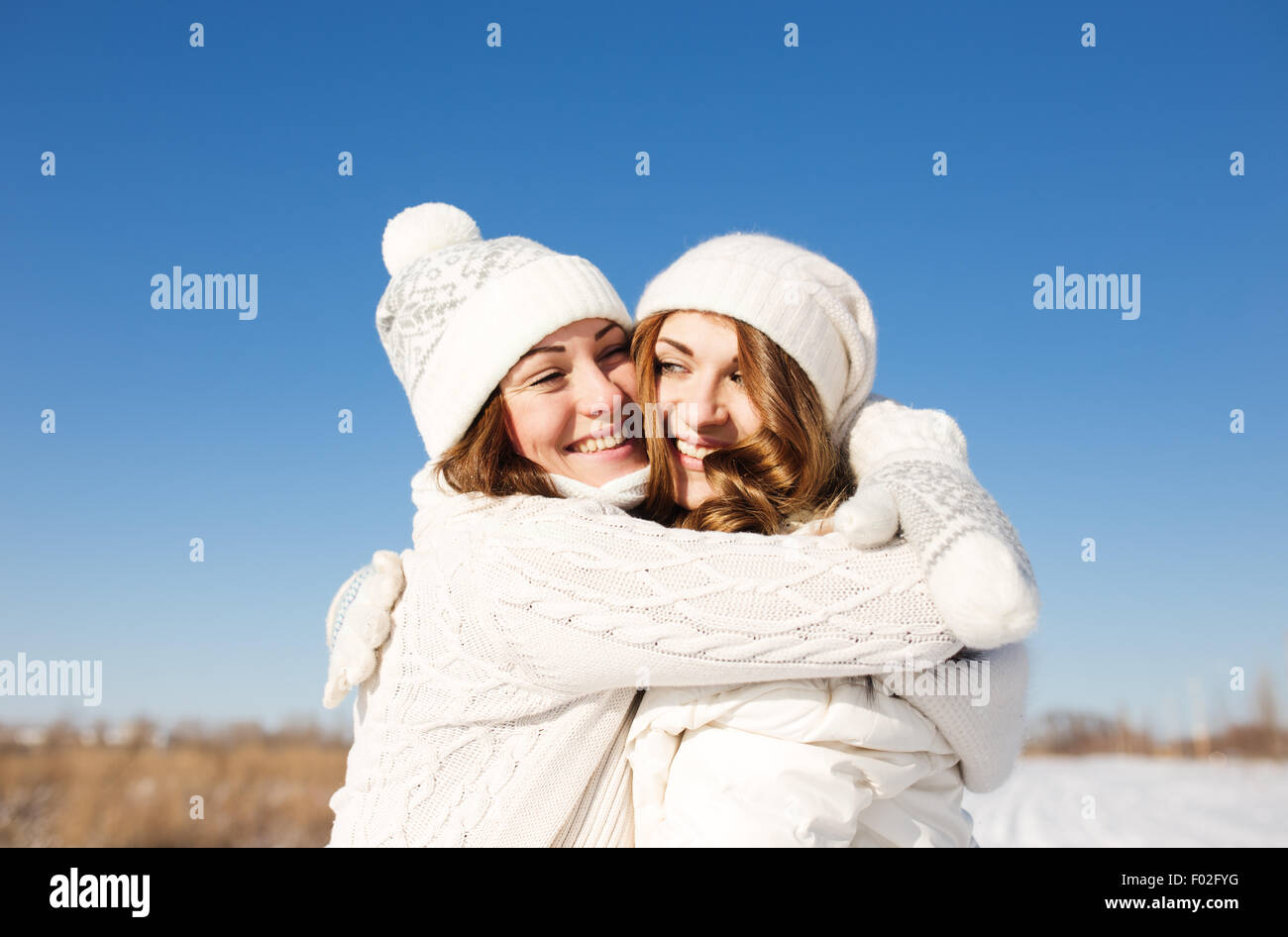 Deux copines s'amuser et profiter de la neige fraîche à la belle journée d'hiver Banque D'Images