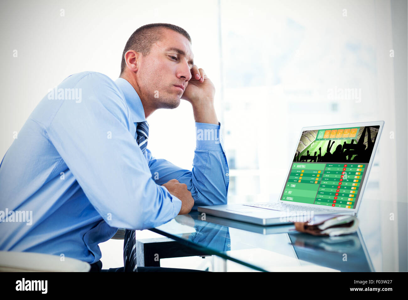 Image composite de fatigué businessman looking at his laptop Banque D'Images