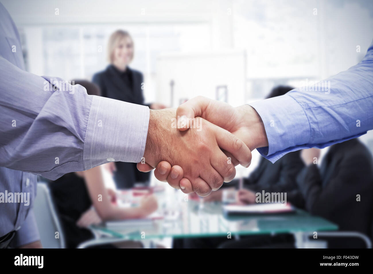 Image composite de men shaking hands Banque D'Images