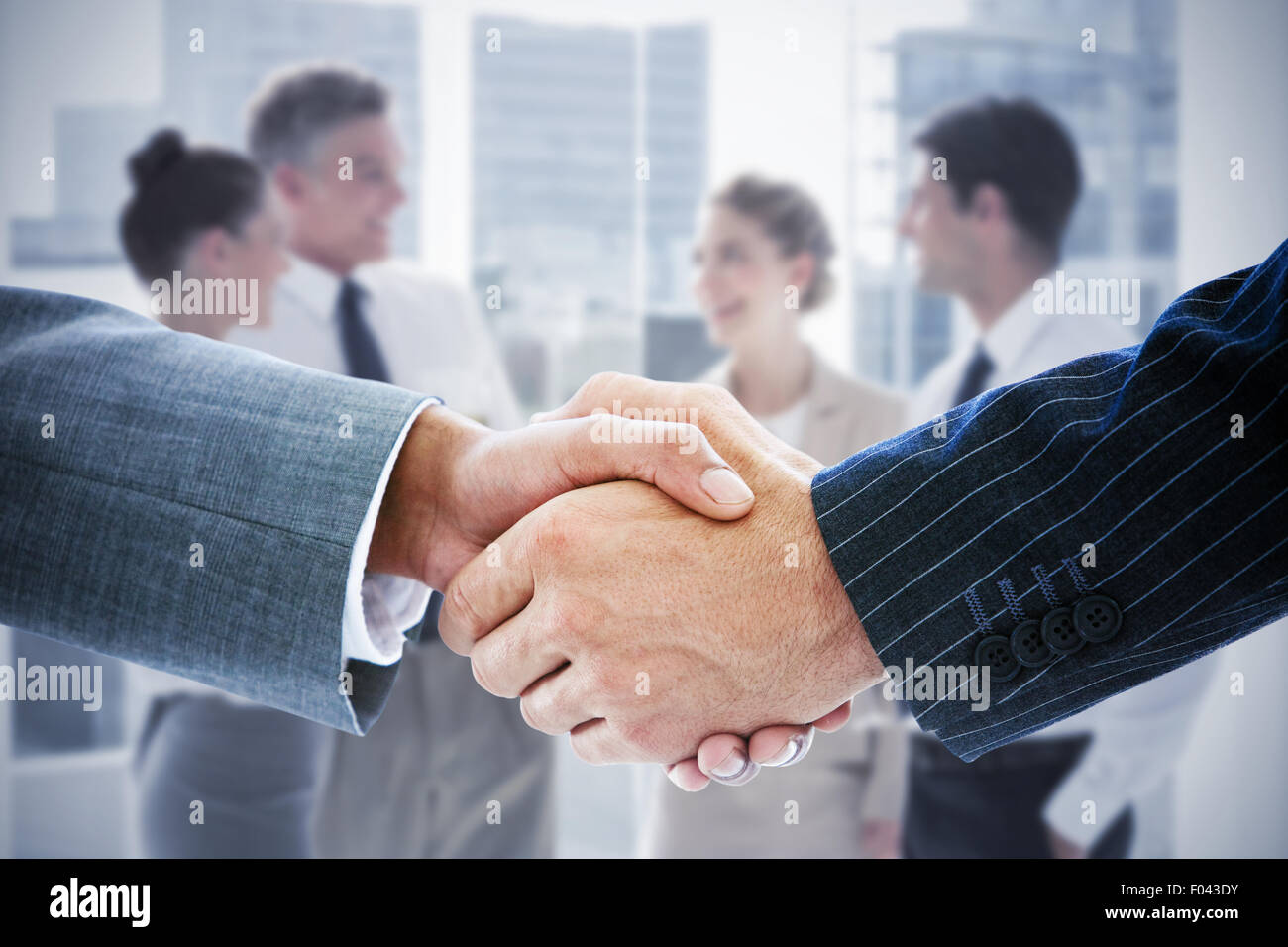Image composite de business people shaking hands Banque D'Images