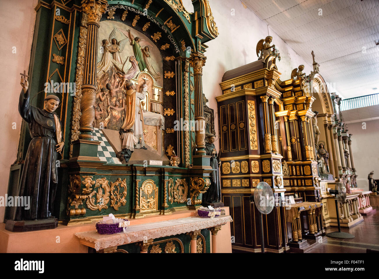 PANAMA CITY, Panama — des autels latéraux ornés (retablos) bordent les murs de la nef d'Iglesia San José, illustrant l'art et l'artisanat religieux coloniaux espagnols. Ces autels décoratifs, datant de la période coloniale, présentent des détails artistiques religieux élaborés typiques de la décoration des églises coloniales. La série d'autels latéraux démontre la riche tradition de l'ameublement liturgique catholique dans le Panama colonial. Banque D'Images