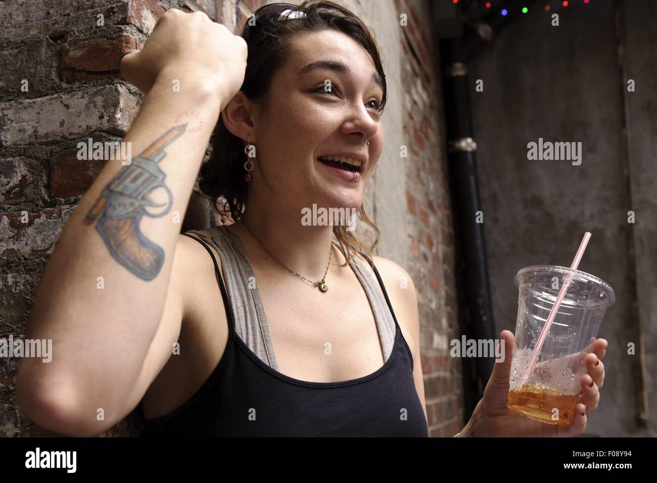Femme Avec Tatouage Au Bras Tenant La Bière Dans La Main