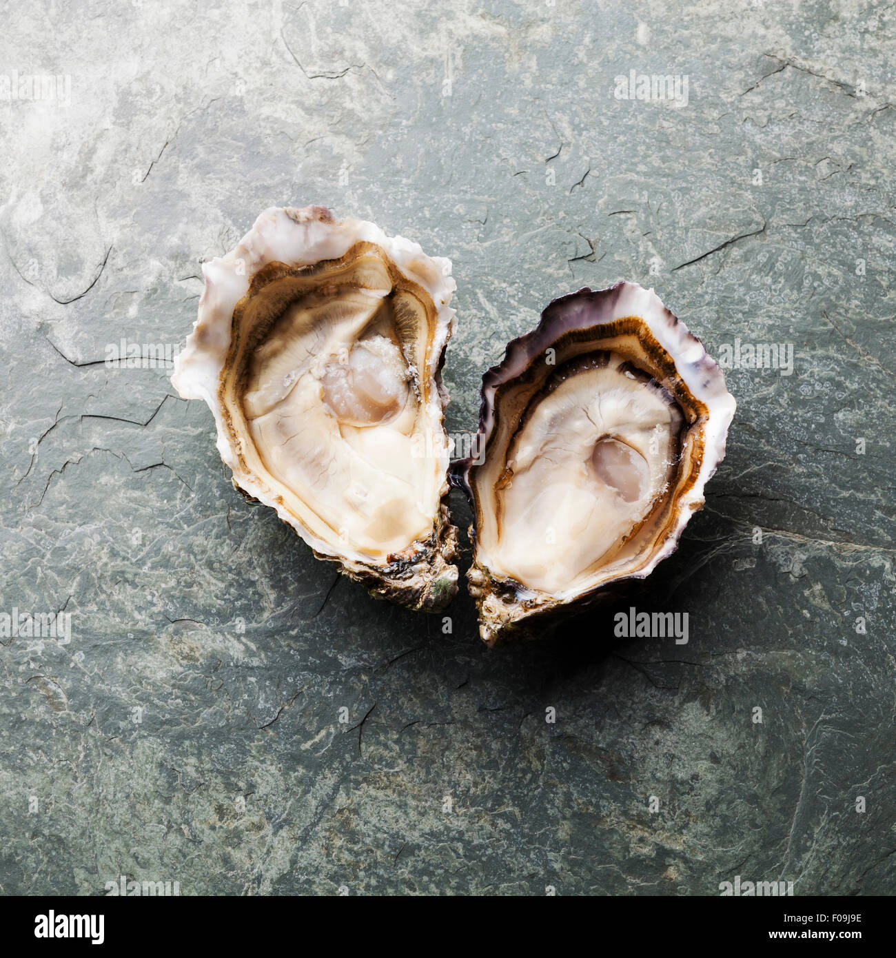 Forme de coeur les huîtres sur fond de plaque en pierre Banque D'Images