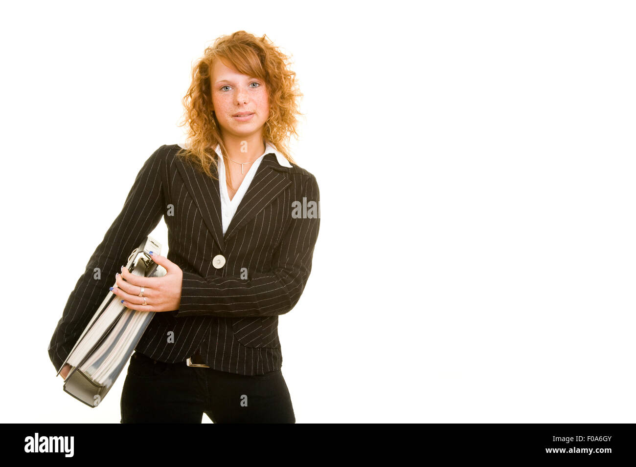 Redhaired femelle transportant des étudiants les fichiers sous son bras Banque D'Images
