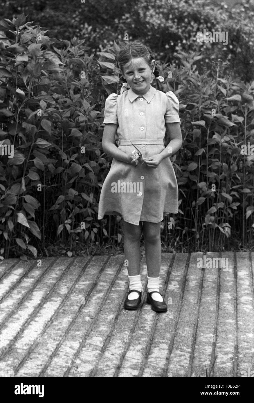 Une petite fille aux cheveux noirs avec des nattes Banque D'Images