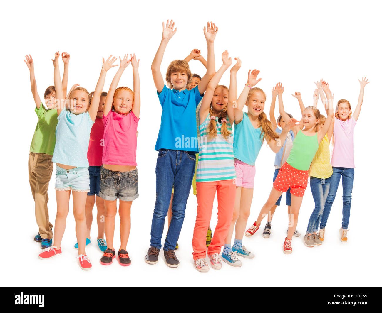 Groupe d'enfants heureux avec les mains posées sur blanc Banque D'Images