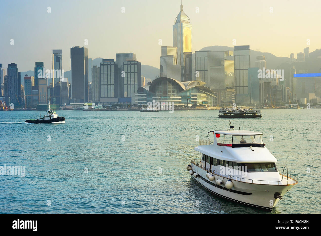 Yacht de luxe dans le port de Hong Kong au coucher du soleil Banque D'Images
