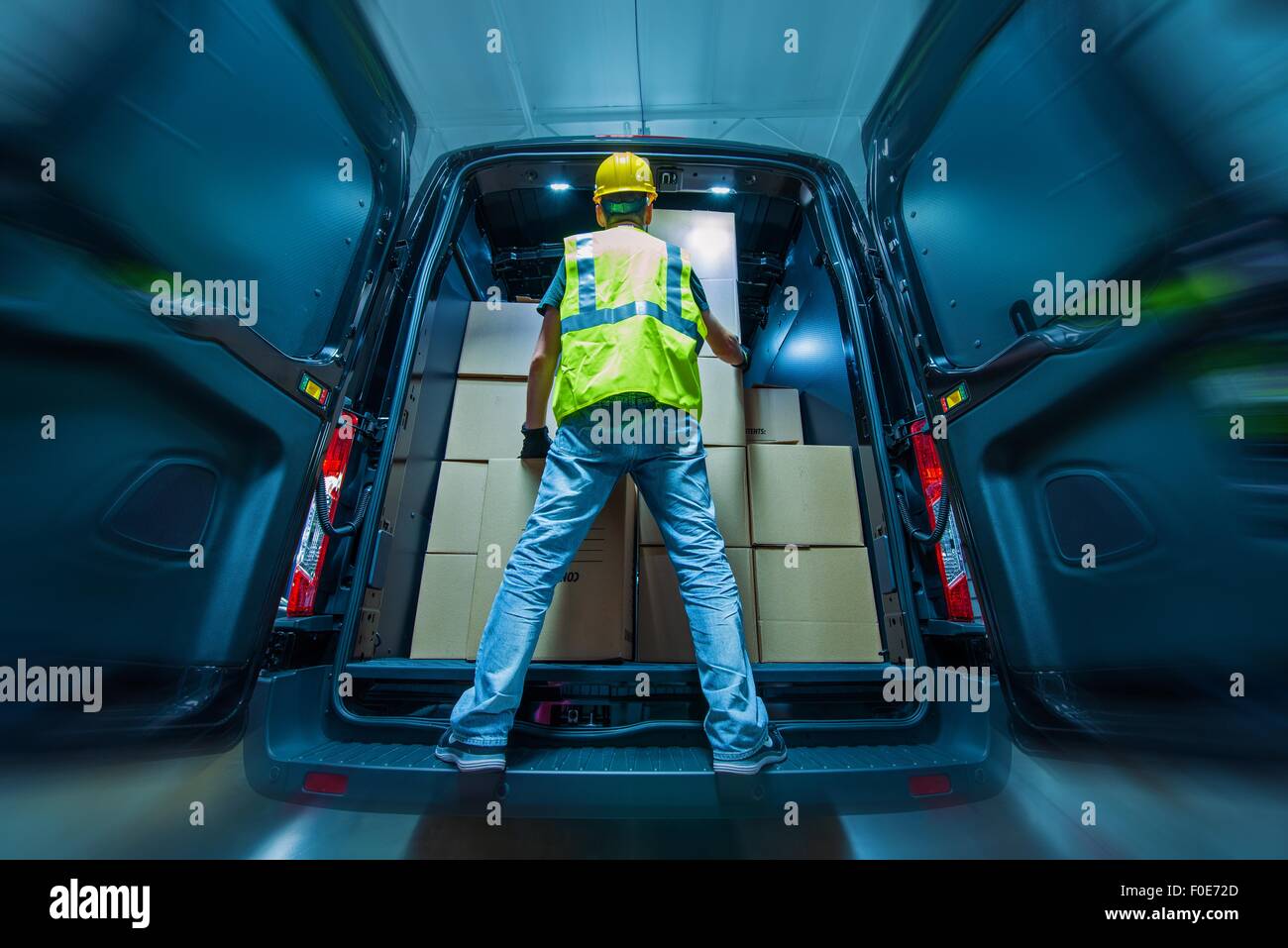 Heavy Duty grand Cargo Van Chargement par les hommes en casque jaune. Thème de la logistique et de l'expédition. Banque D'Images