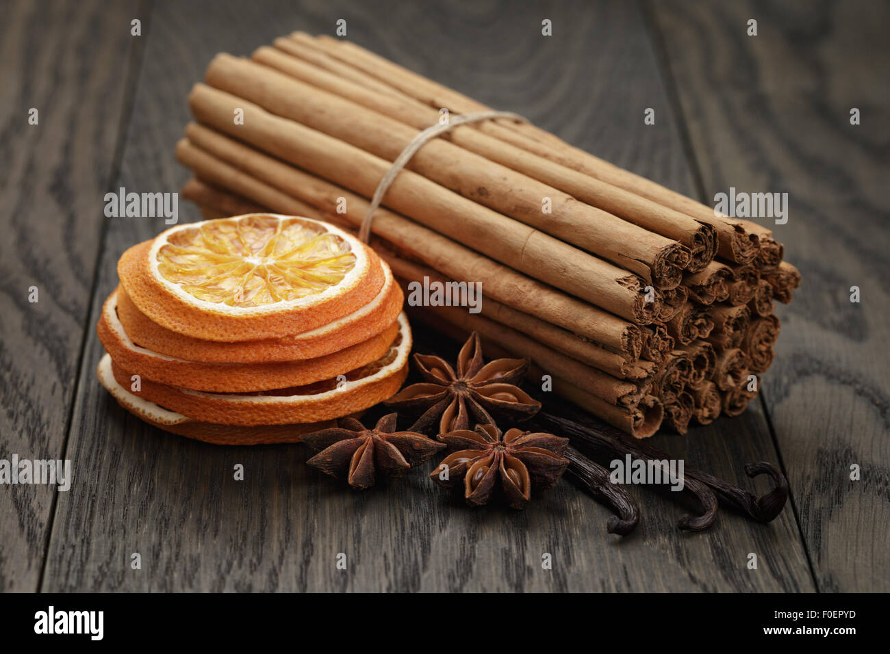 Vrai Les bâtons de cannelle et oranges séchées, table en chêne Banque D'Images