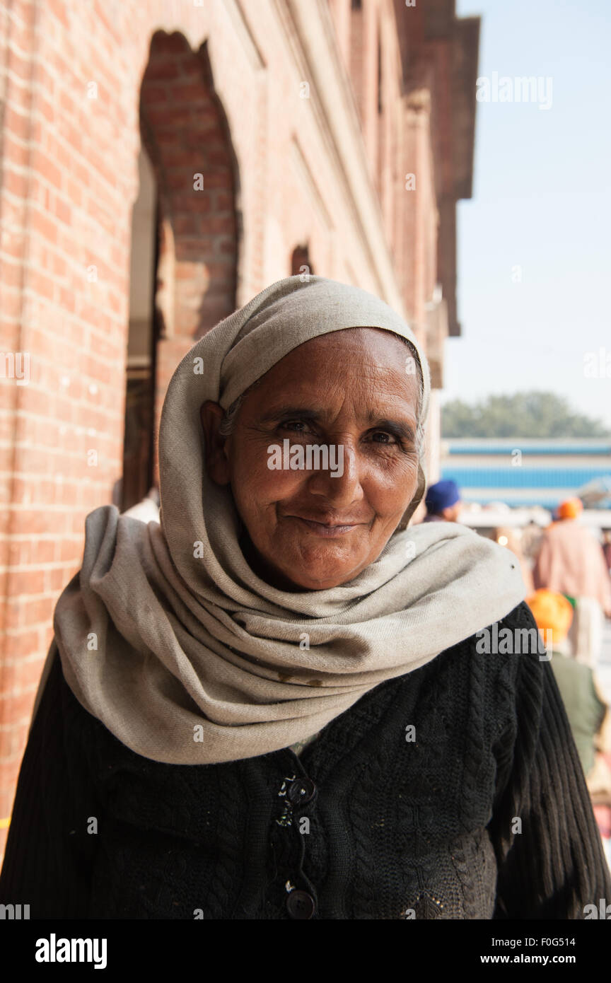 Amritsar, Punjab, en Inde. A smiling woman adorateur avec foulard à la Sri Harmandir Sahib Golden Temple. Banque D'Images