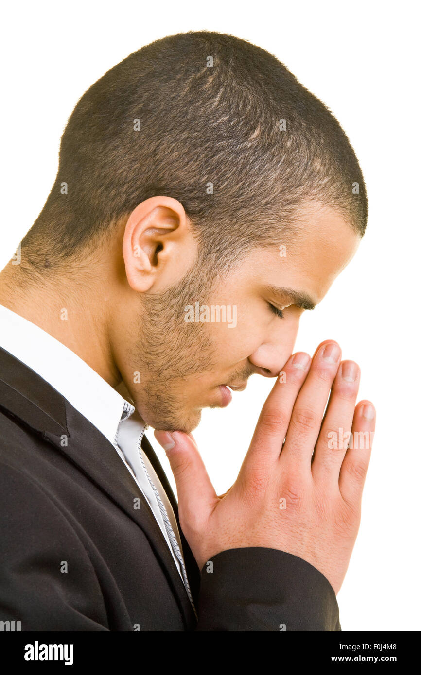 Jeune homme d'affaires en priant avec mains jointes Banque D'Images