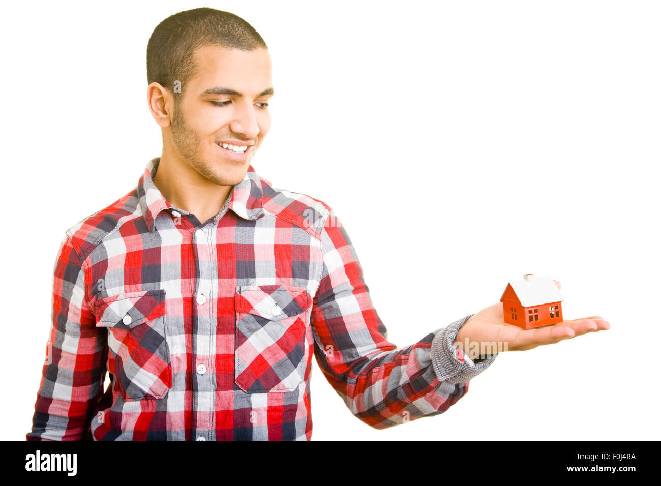 Young happy man holding a small miniature house Banque D'Images