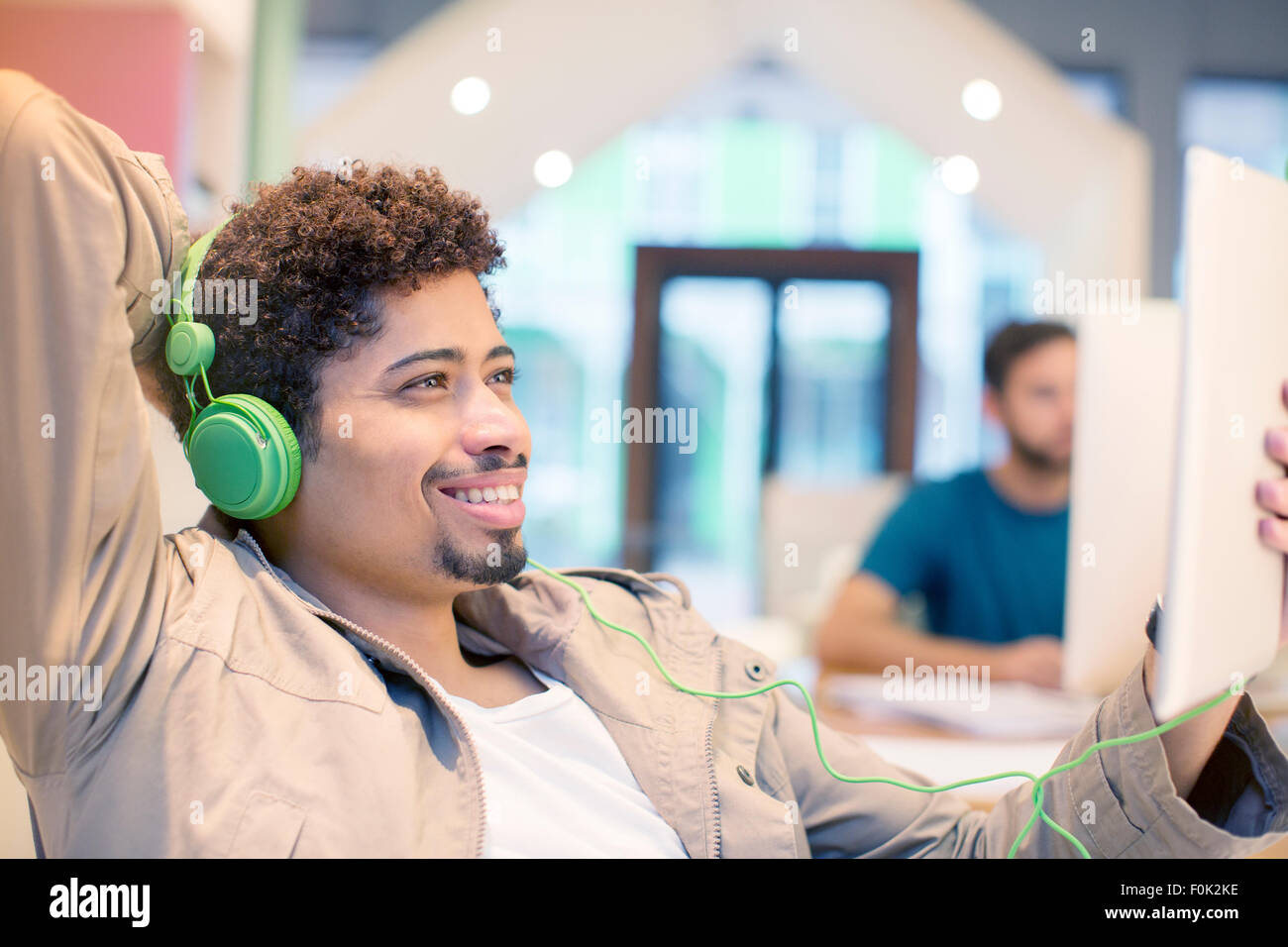 Creative businessman listening to headphones and using digital tablet Banque D'Images