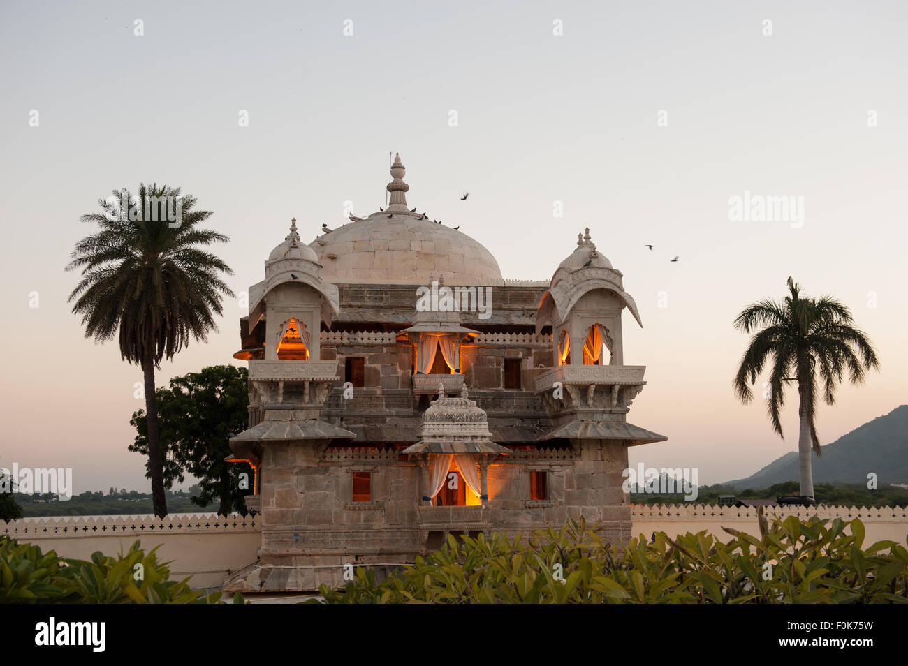 Udaipur, Rajasthan, Inde. Palais Jagmandir, inspiration pour le Taj Mahal. Le lac Pichola. En soirée. Banque D'Images