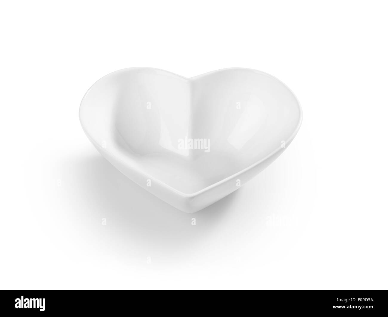 Tiré d'un bol de céréales en forme de coeur découpé et isolé sur blanc. Banque D'Images Tiré d'un bol de céréales en forme de coeur découpé et isolé sur blanc. Banque D'Images