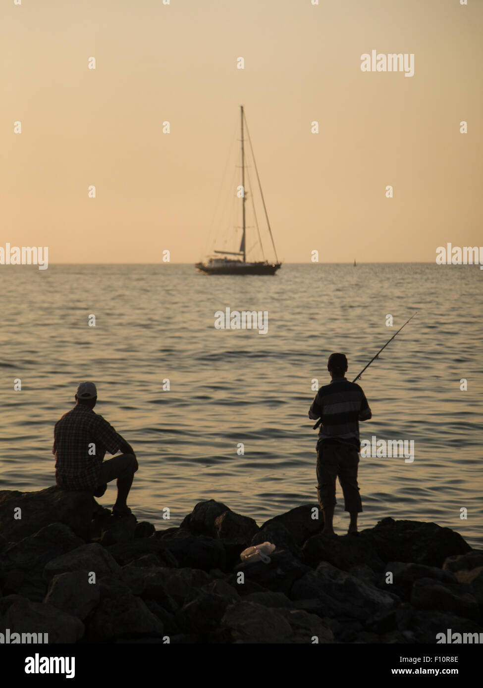Silhouette de pêcheur et un bateau à Kusadasi, Turquie Banque D'Images