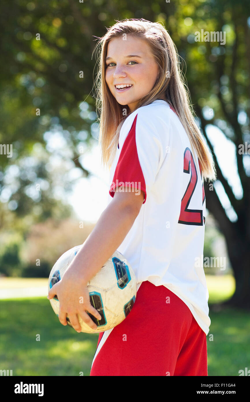 Young soccer player holding ball Banque D'Images