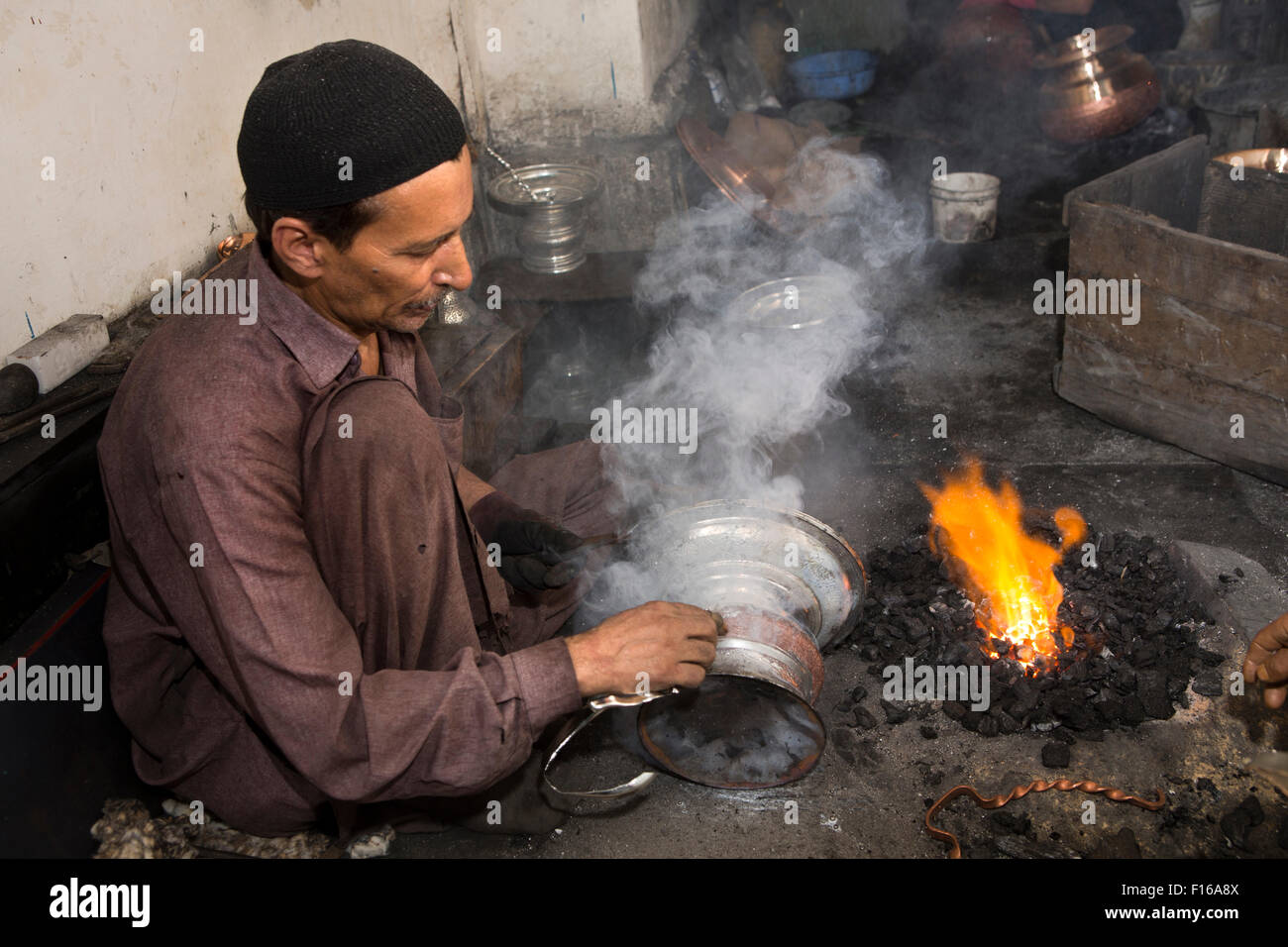 L'Inde, le Jammu-et-Cachemire, Srinagar, vieille ville, Sri Ranbir Gunj bazaar, artisan l'application de placage argent cuivre chaud de navire Banque D'Images