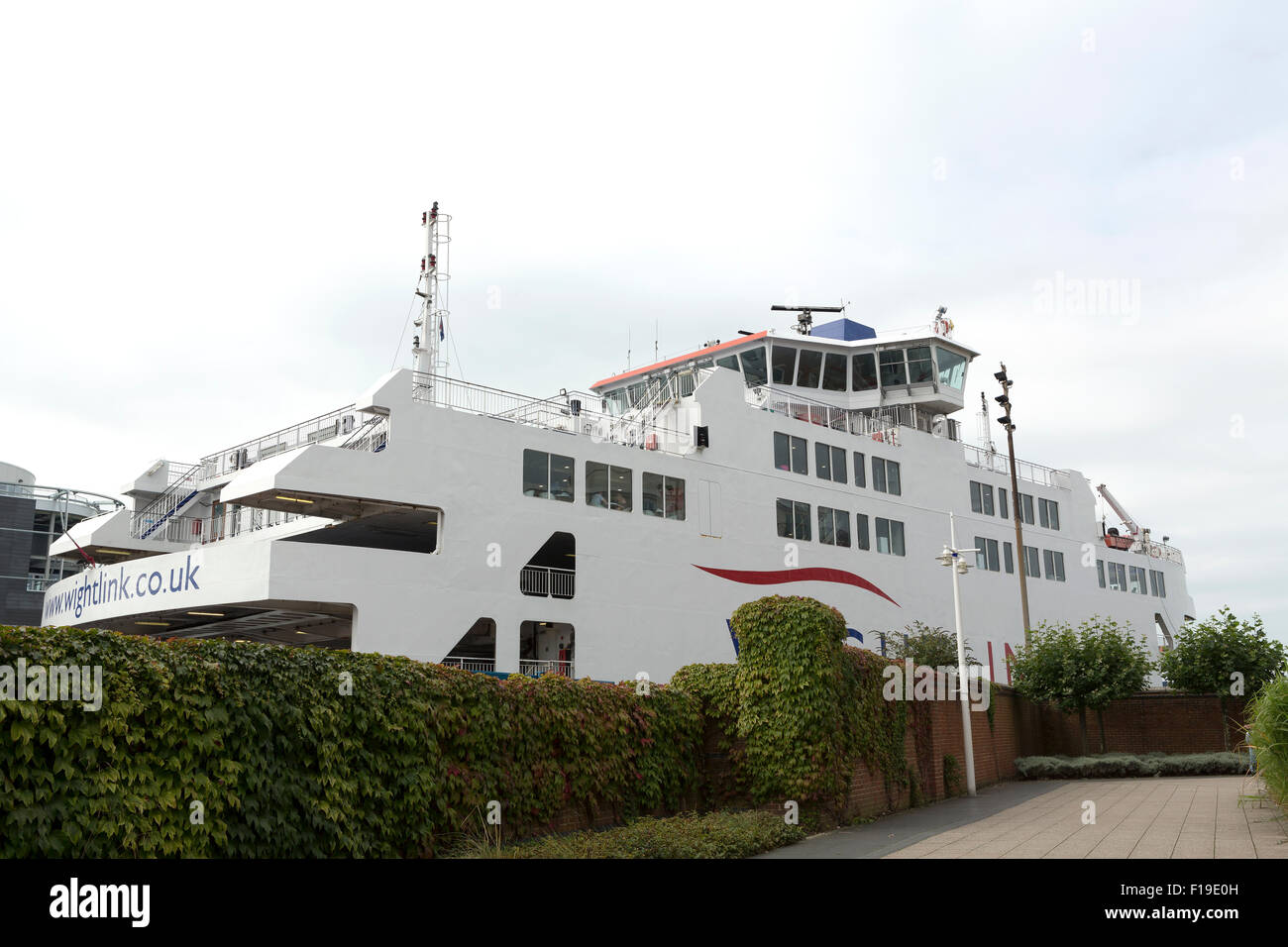 Traversier dans le jardin ! L'île de Wight car-ferry avec le dock à Portsmouth. Ferry est derrière un mur de jardin couvert de lierre. Banque D'Images