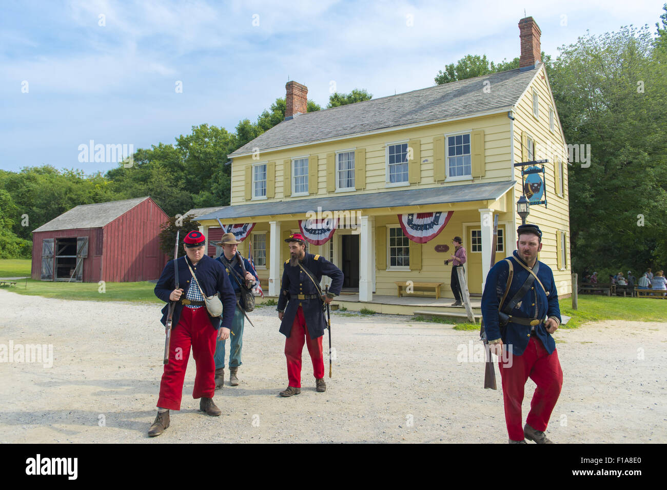 Old Bethpage, New York, USA. Août 30, 2015. La guerre civile américaine des soldats de la 14e Régiment de Brooklyn (14e New York State Militia) AKA Le Brooklyn Chasseurs, sont représentées à l'avant du jaune et blanc Midi Inn tavern pendant l'ancien temps Music Week-end à l'ancien Bethpage Village Restauration. Au cours de leurs reconstitutions historiques, les membres de l'association sans but lucratif Société Brooklyn 14e E porter des reproductions exactes de ''Le ''Red Devils pattes'' uniforme de l'armée de l'Union européenne d'origine. Credit : Ann Parry/ZUMA/Alamy Fil Live News Banque D'Images