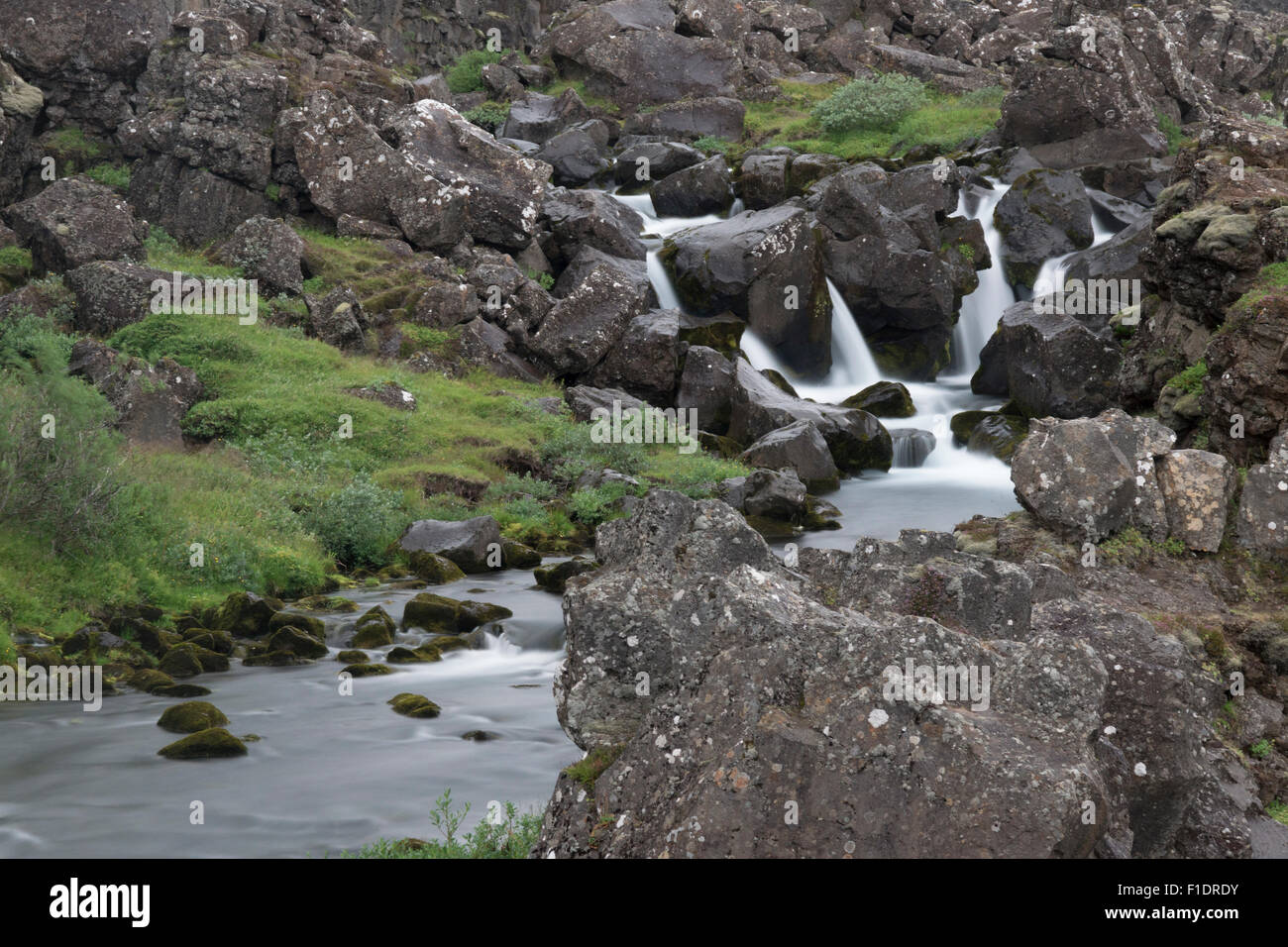 Une longue exposition avec de l'eau floue à la chute d'eau d'Oxararfoss au parc national de Pingvellir, en Islande Banque D'Images