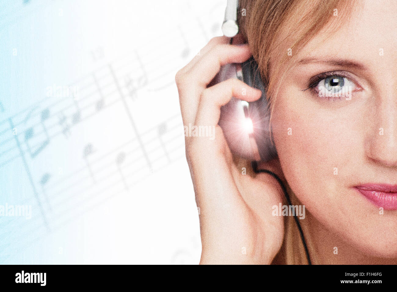 Blonde woman wearing headphones listening to music Banque D'Images