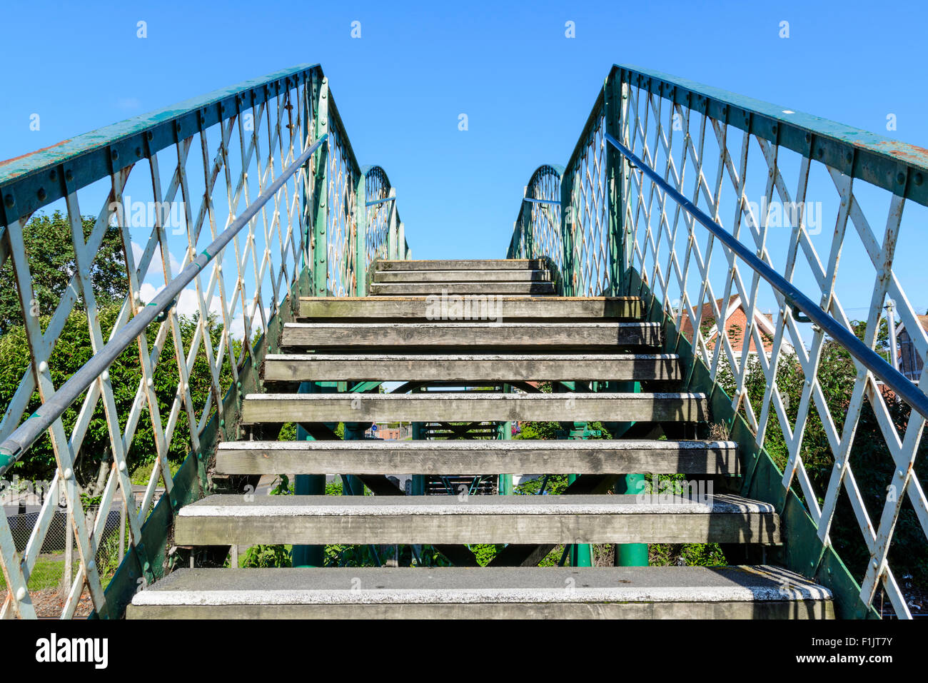 Marches sur une ancienne passerelle piétonne traversant une ligne de chemin de fer au Royaume-Uni. Banque D'Images