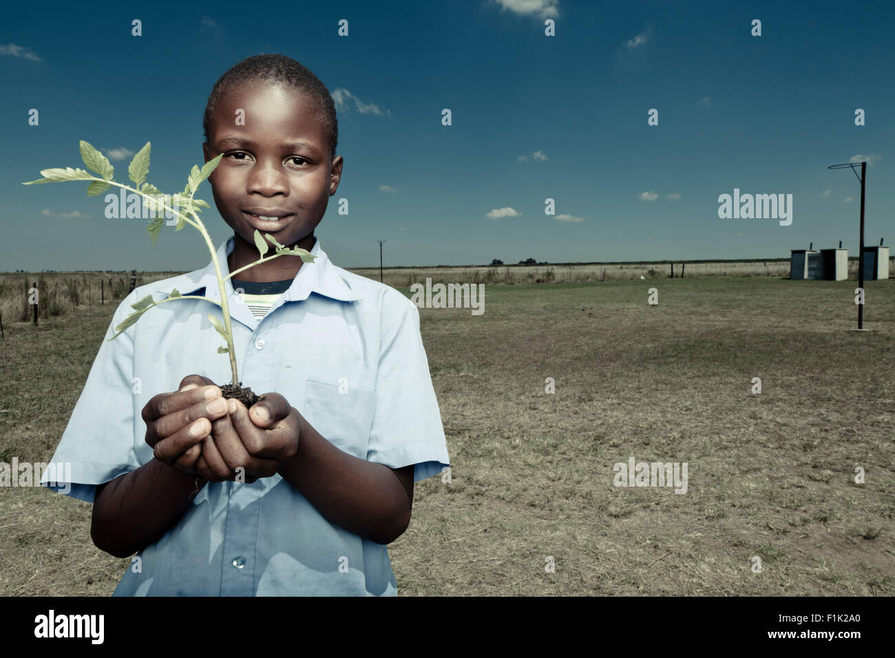 African Male student standing outside, smiling at camera Banque D'Images