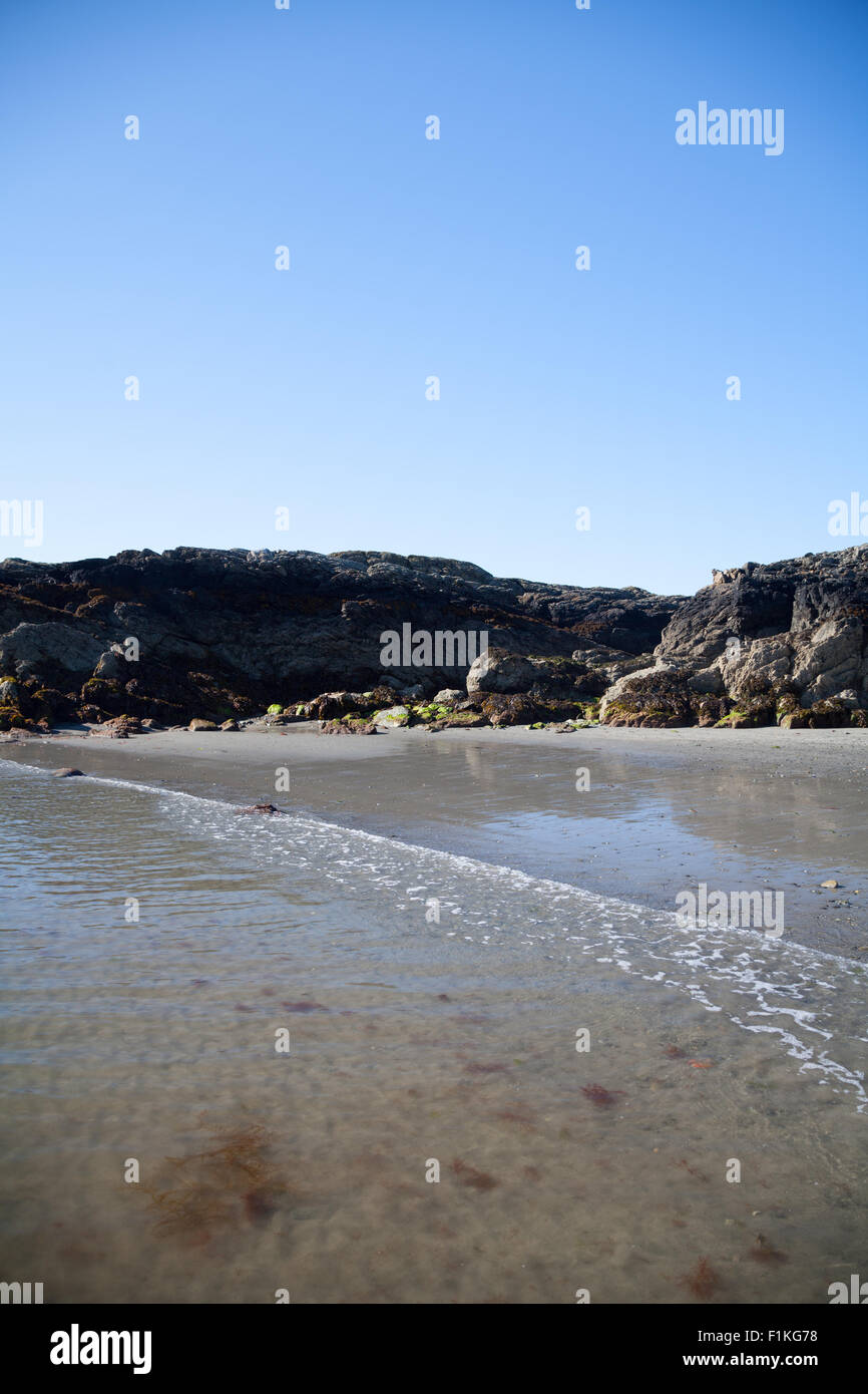 Le calme de la mer des circuits à la plage de Porth, Ysgaden Tudweiliog, Llyn Peninsula, au nord du Pays de Galles par un beau jour d'été ensoleillé Banque D'Images