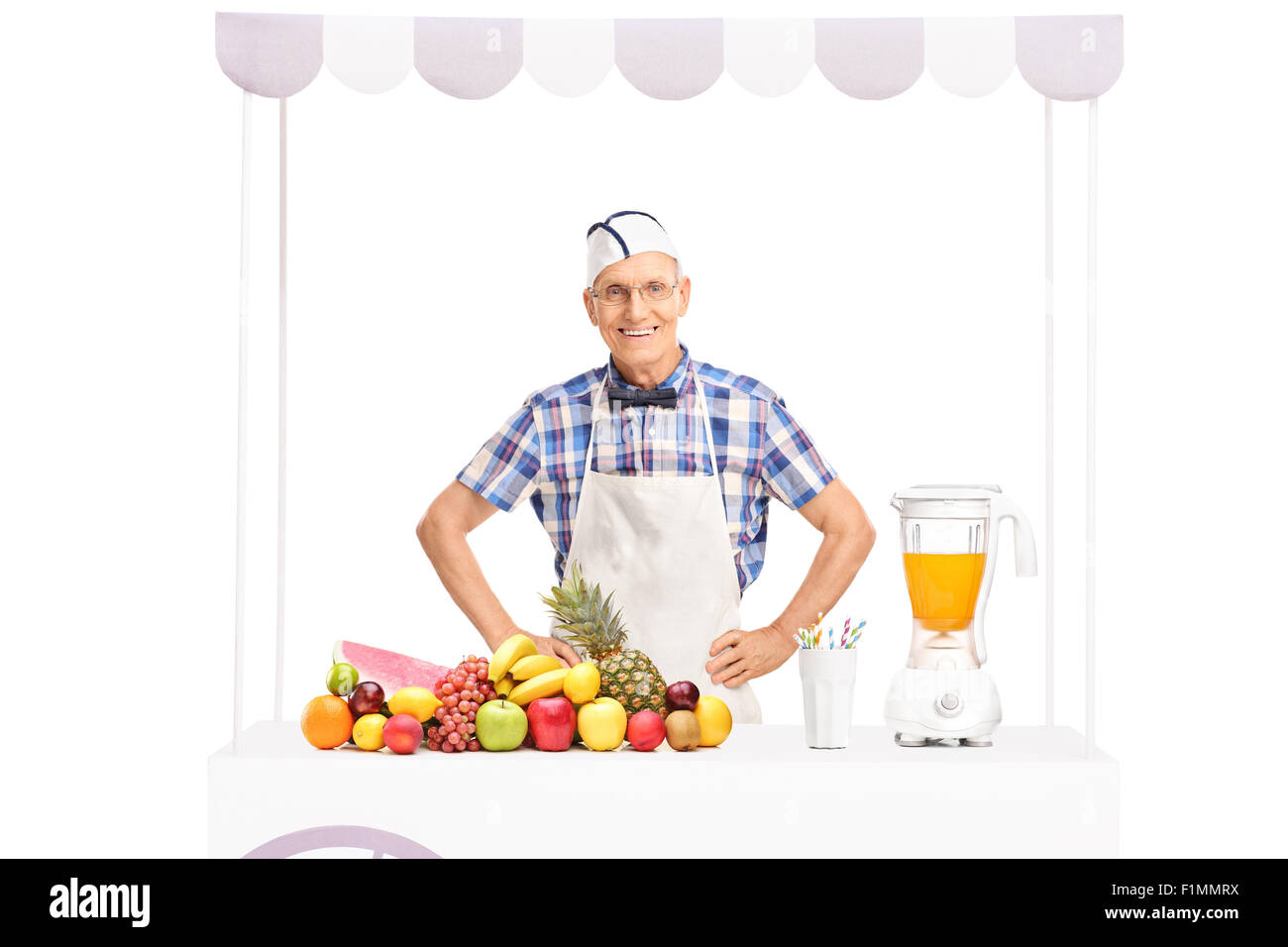 La soude en maturité jerk tablier blanc debout derrière un stand plein de fruits frais isolé sur fond blanc Banque D'Images